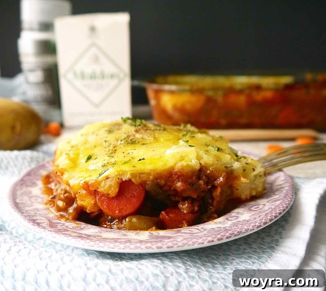 Ancestral Lamb Pie 3 A serving of Paleo Shepherd's Pie on a white plate, showcasing the golden crust and rich filling.
