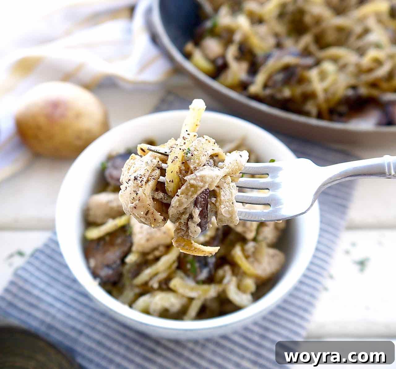 Wholesome Chicken, Mushroom and Spiral Potato Bake 8 A top-down view of the rustic mushroom, chicken, and spiralized potato casserole, fresh out of the oven, with a golden-brown top.