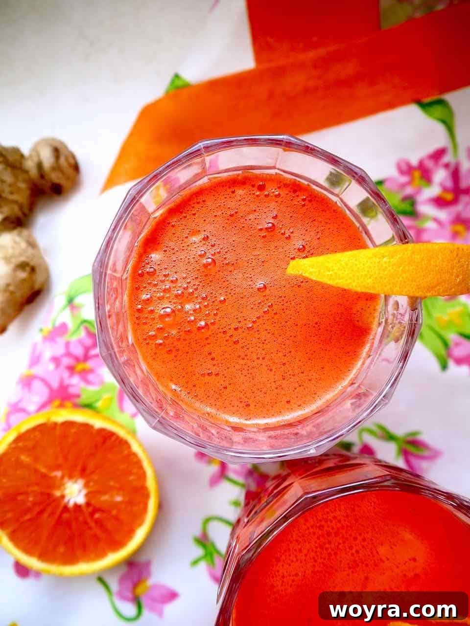 Vibrant Harvest Elixir 2 Apple carrot beet ginger juice in a glass.
