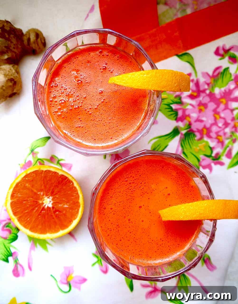Vibrant Harvest Elixir 3 Apple Carrot Beet Ginger Juice in two cups.