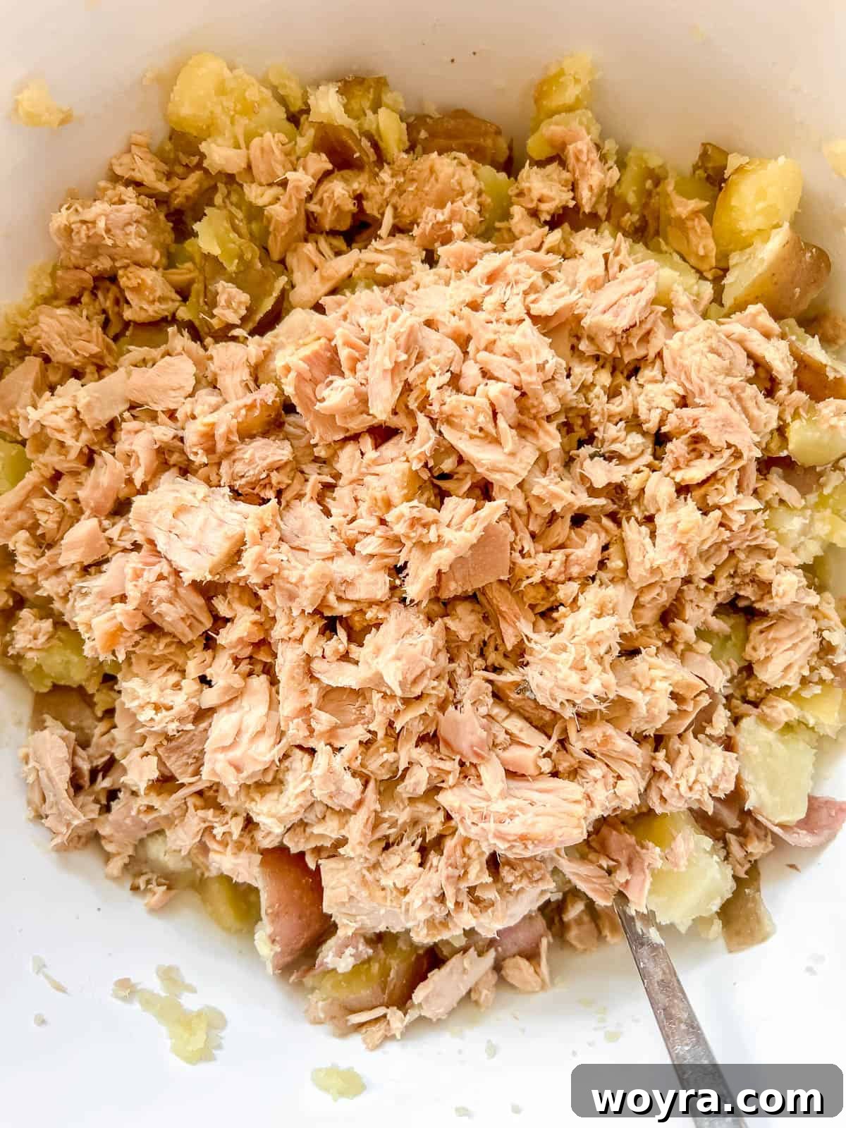 Paleo Whole30 French Tuna Potato Salad 7 Cooked potatoes and flaked tuna combined in a large mixing bowl.