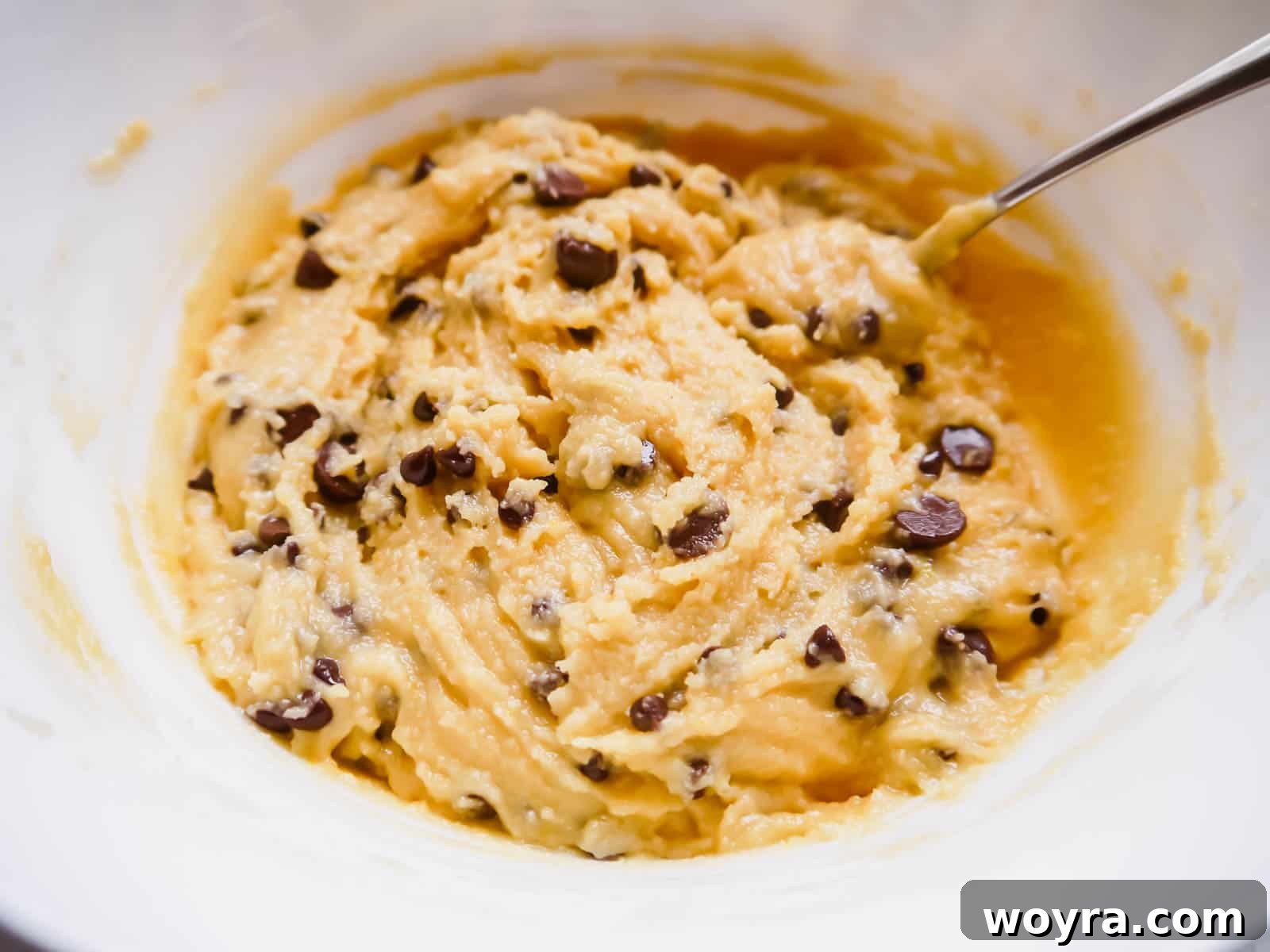 Bowl of soft almond flour chocolate chip cookie batter, showing its smooth, cohesive texture before chocolate chips are folded in.
