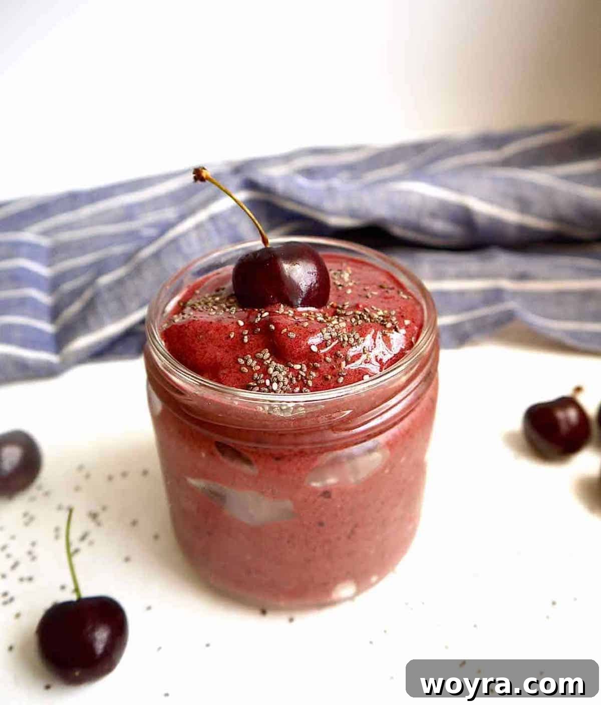 Chocolate Cherry Banana Dream Smoothie 2 Vibrant chocolate cherry banana smoothie in a glass jar, topped with chia seeds, ready to enjoy.