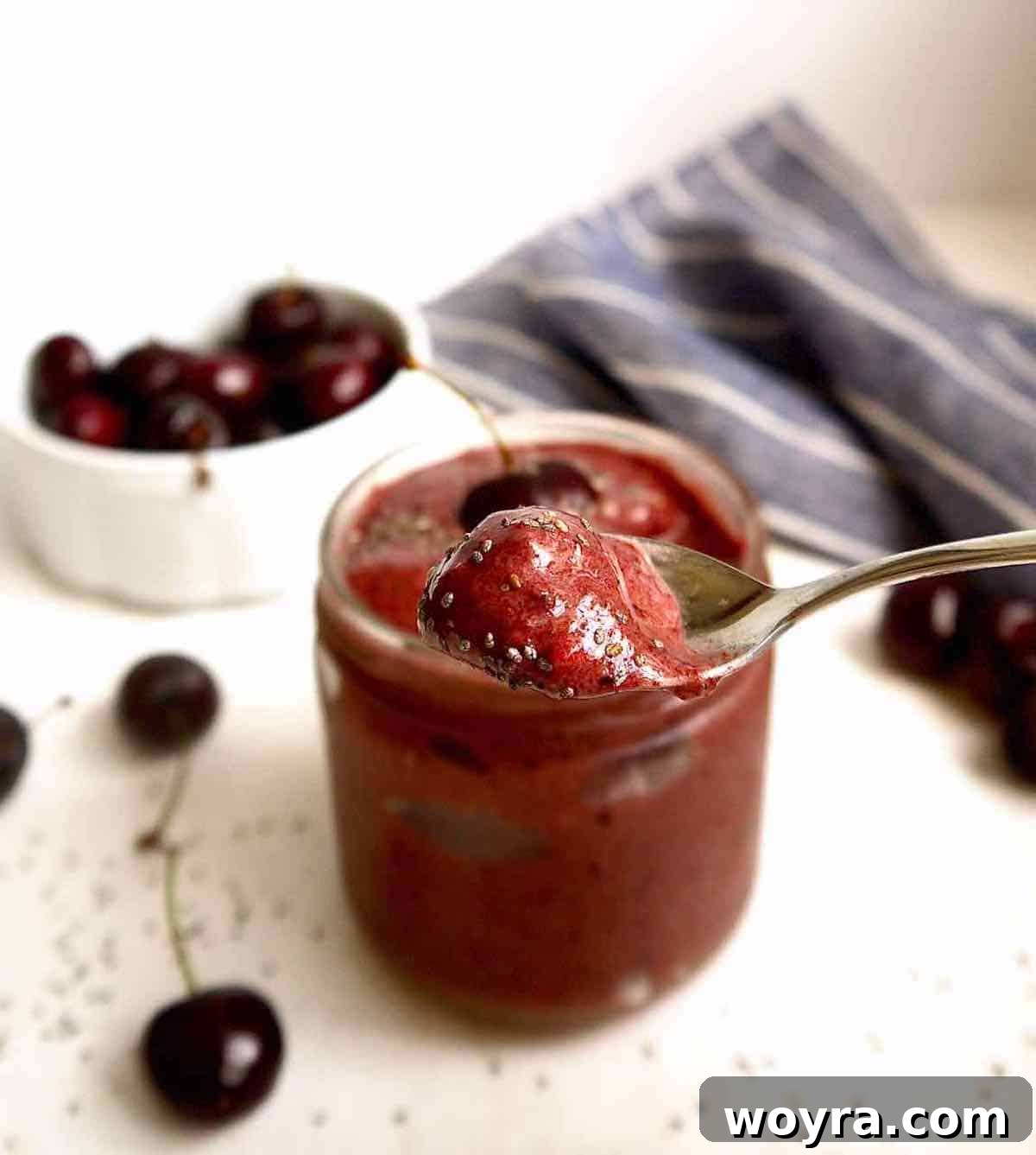 Chocolate Cherry Banana Dream Smoothie 4 A spoon scooping a portion of the thick cherry smoothie, showcasing its creamy texture.