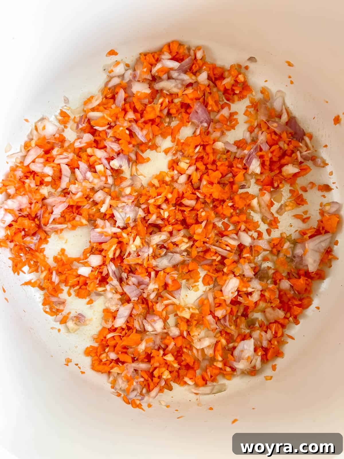 Wild Bison Ragu 4 Minced carrot, onion, and garlic in a pan.