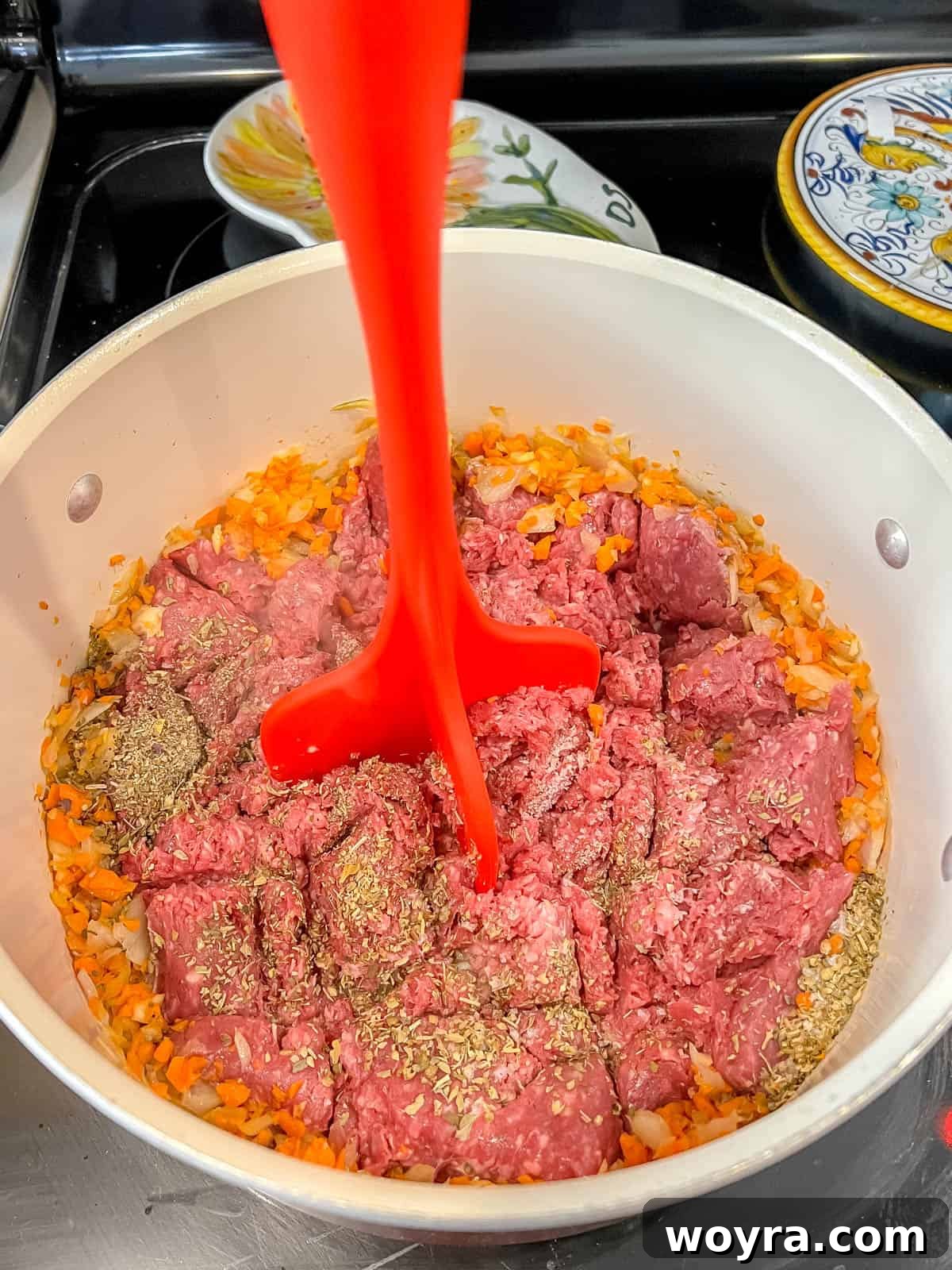 Wild Bison Ragu 6 Using a meat masher to mash the meat.
