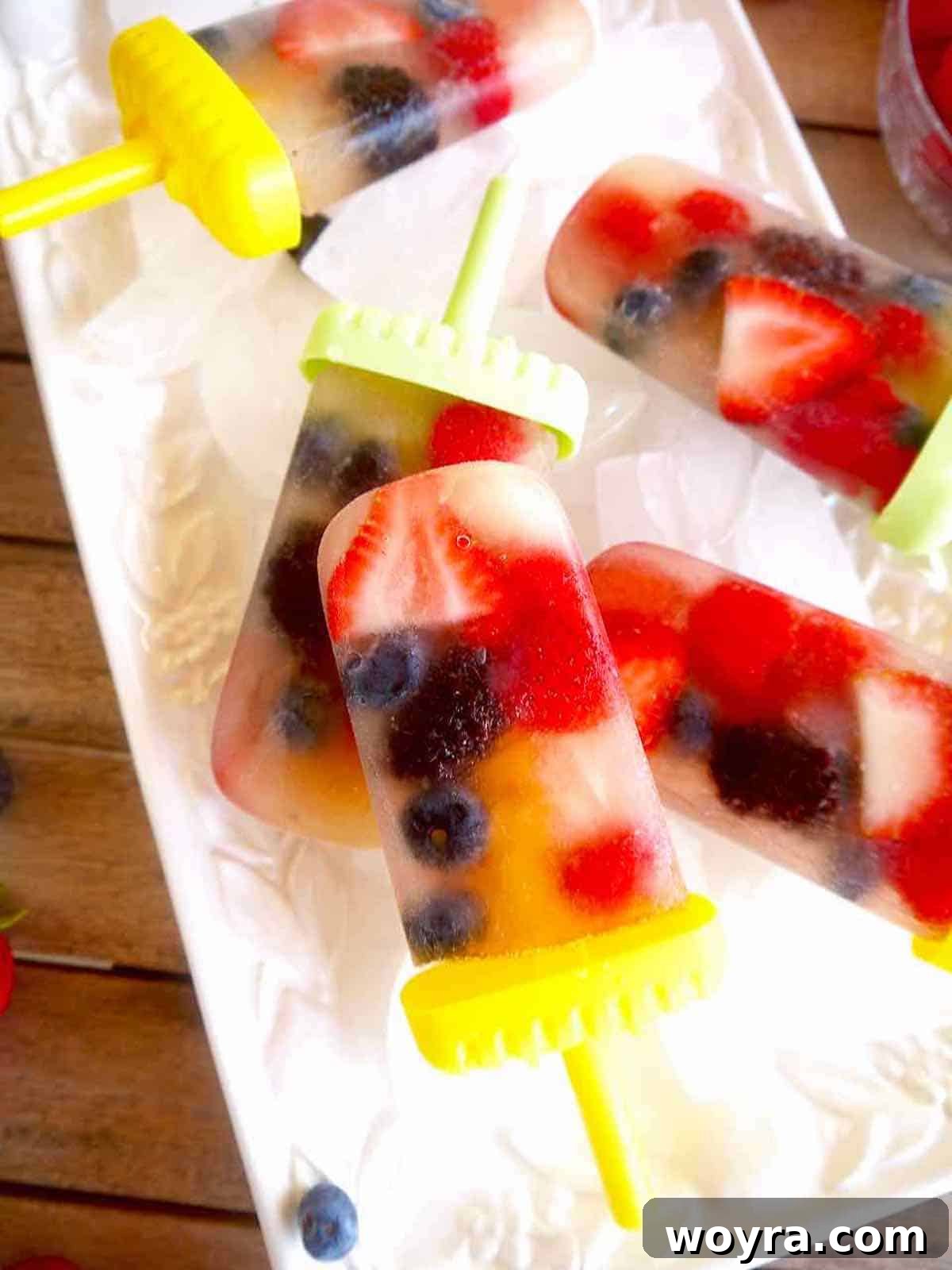 Apple Berry Freeze Pops 8 Frozen apple juice popsicles showcasing their vibrant appearance.