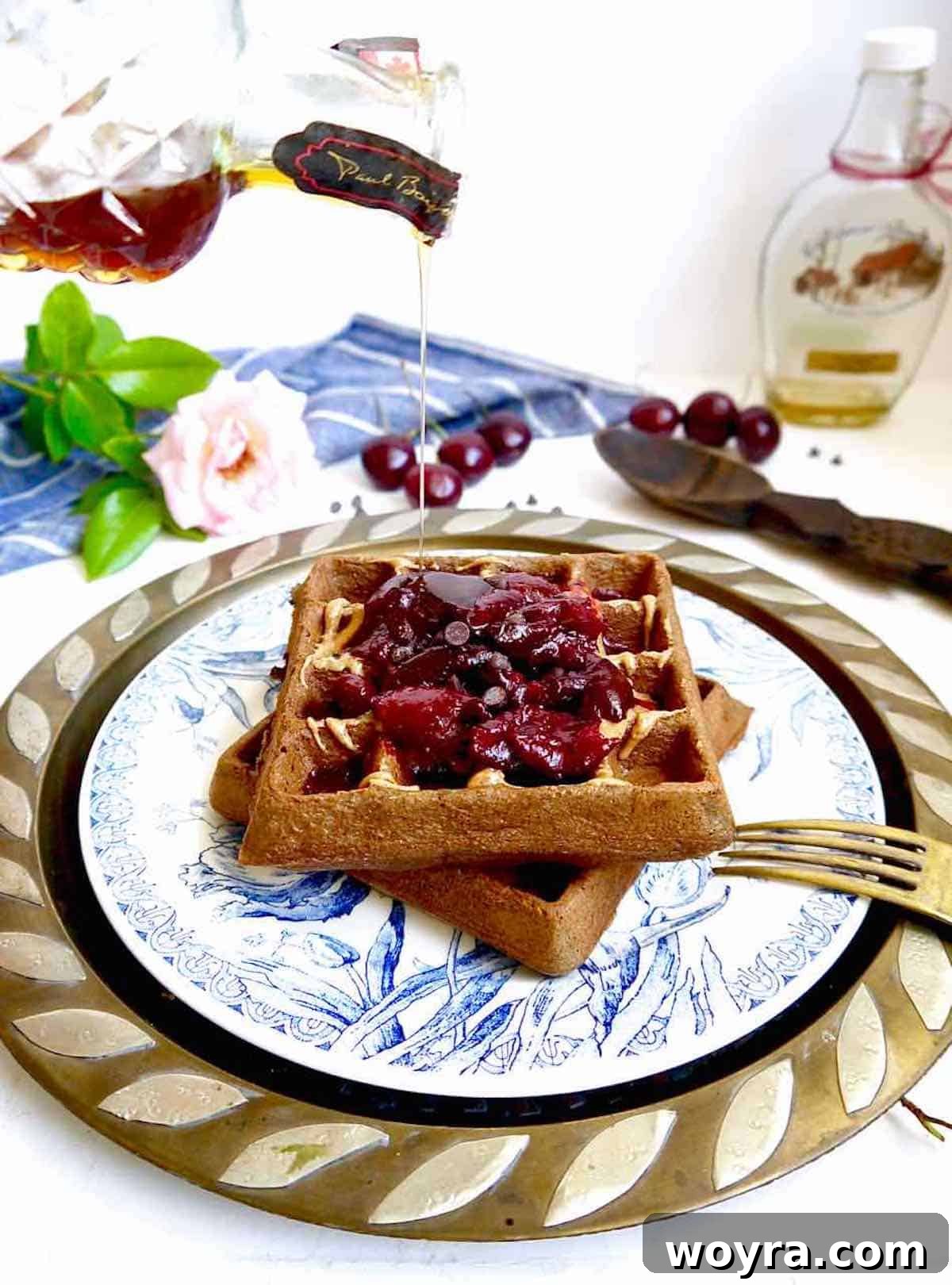 Decadent Paleo Chocolate Cherry Waffles 6 Freshly cooked Paleo chocolate cherry waffles piled on a plate.