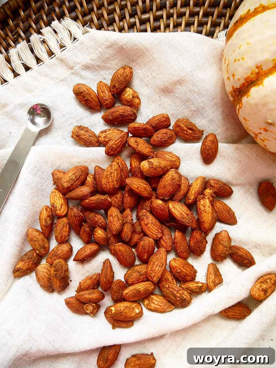 Toasted Pumpkin Spice Almonds 4 Pumpkin spice roasted almonds elegantly arranged on a rustic napkin, highlighting their texture.