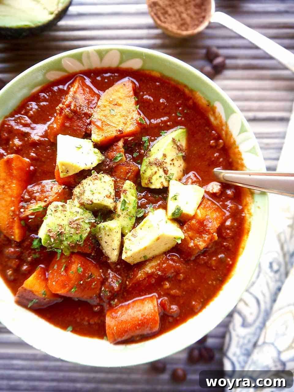 Cocoa powder infusing the chili in a bowl, highlighting its rich color.