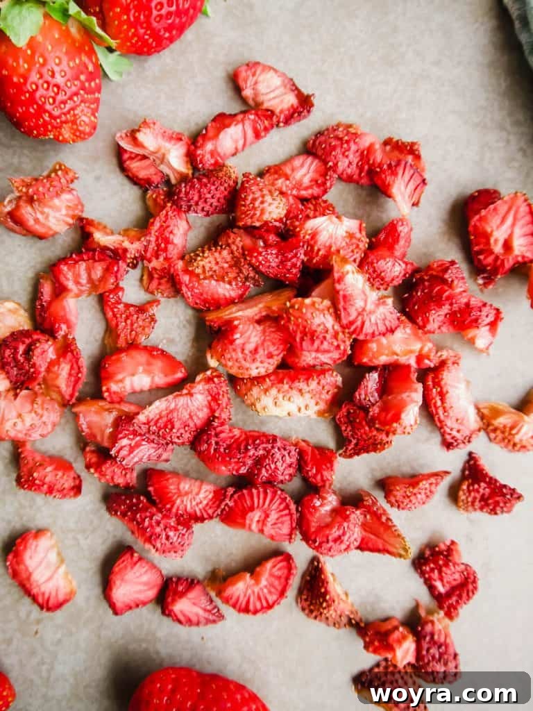 Paleo Gluten-Free Whole30 Friendly Oven Dried Strawberries 2 Perfectly oven-dried strawberries, showcasing their vibrant red color and chewy texture, resembling a healthy gummy candy alternative.
