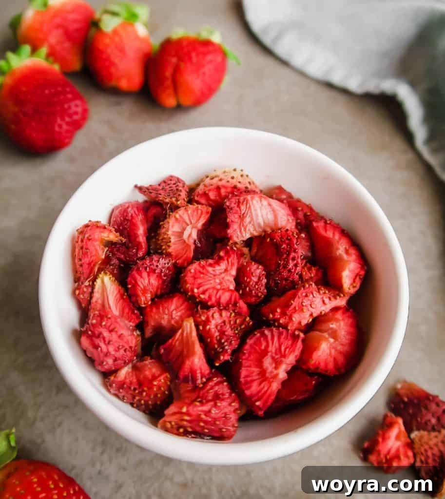 Paleo Gluten-Free Whole30 Friendly Oven Dried Strawberries 3 Close-up of freshly prepared strawberries soaking in apple juice before oven drying, emphasizing the natural ingredients.
