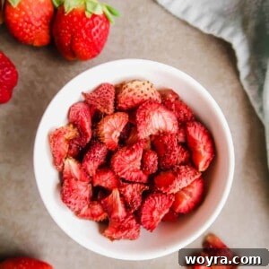 Paleo Gluten-Free Whole30 Friendly Oven Dried Strawberries 6 A small pile of oven-dried strawberries, capturing their rich color and texture, perfect for a healthy snack.