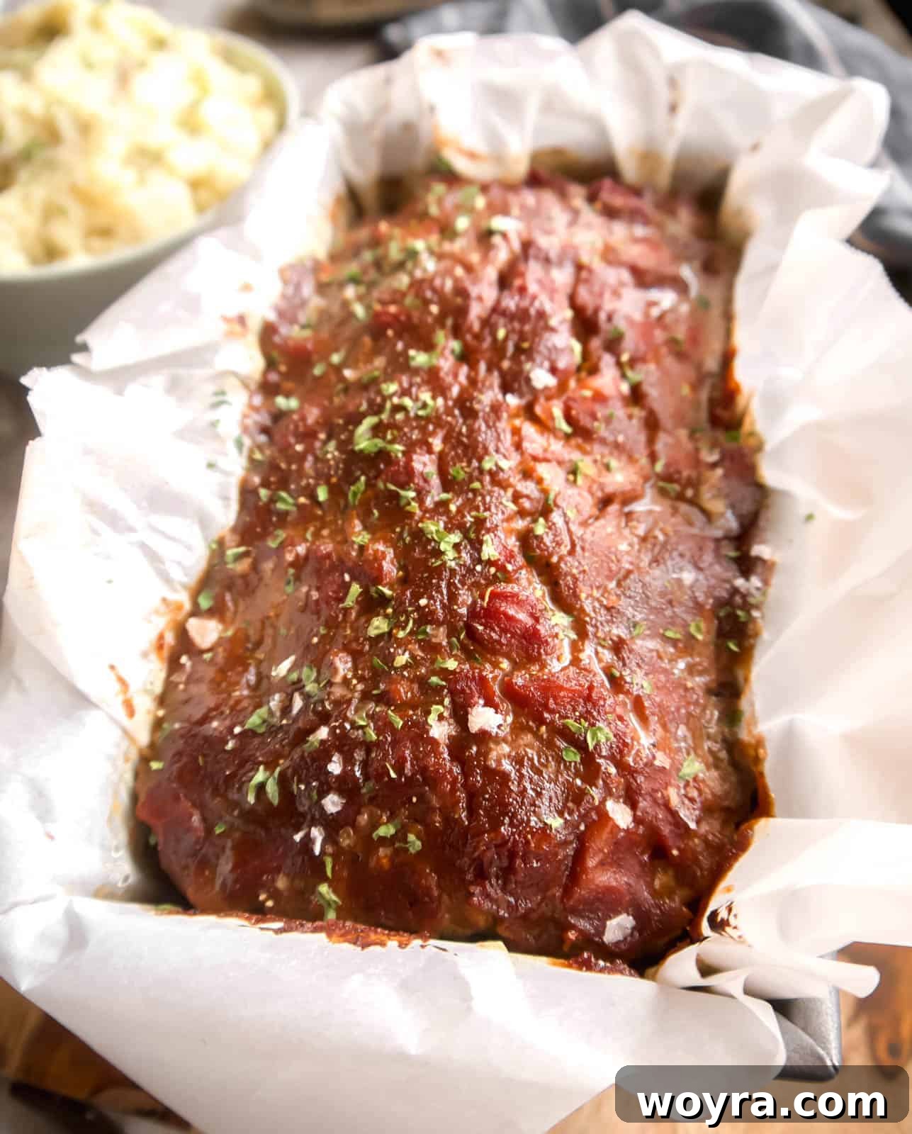 Clean Paleo Meatloaf 2 Paleo meatloaf fresh out of the oven covered in a meatloaf sauce, sliced and ready to serve.