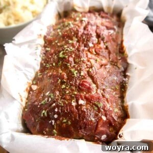 Paleo meatloaf fresh out of the oven covered in a meatloaf sauce.
