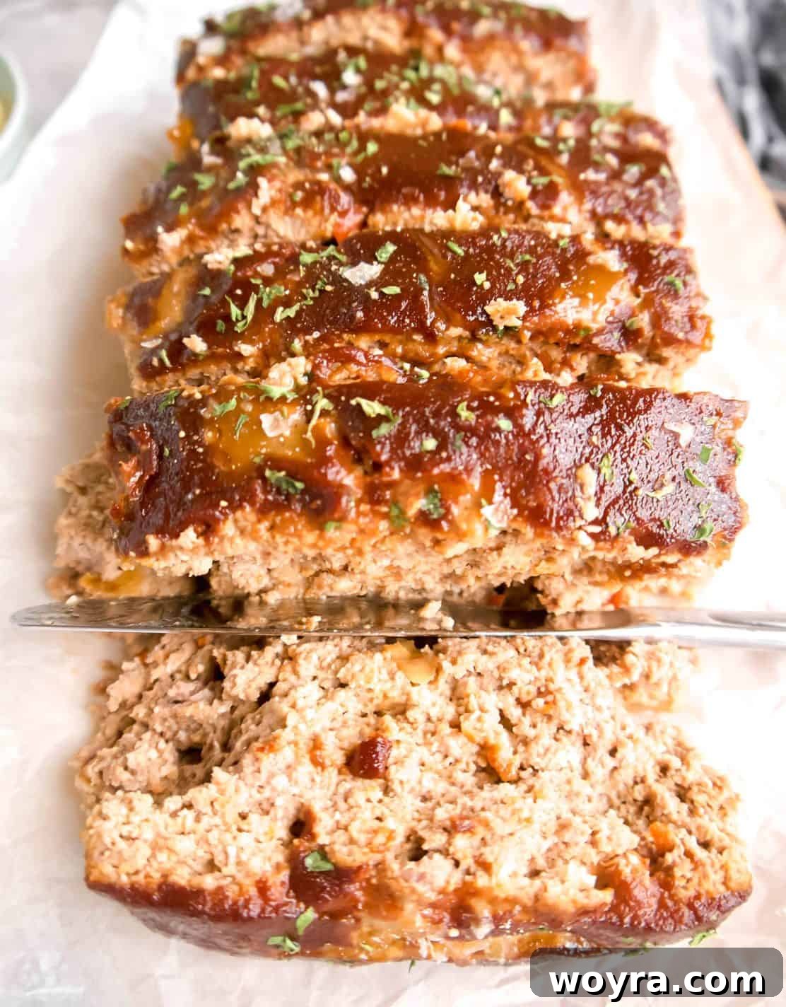 Clean Paleo Meatloaf 3 Slices of delicious paleo meatloaf on a dish, showing its moist texture.