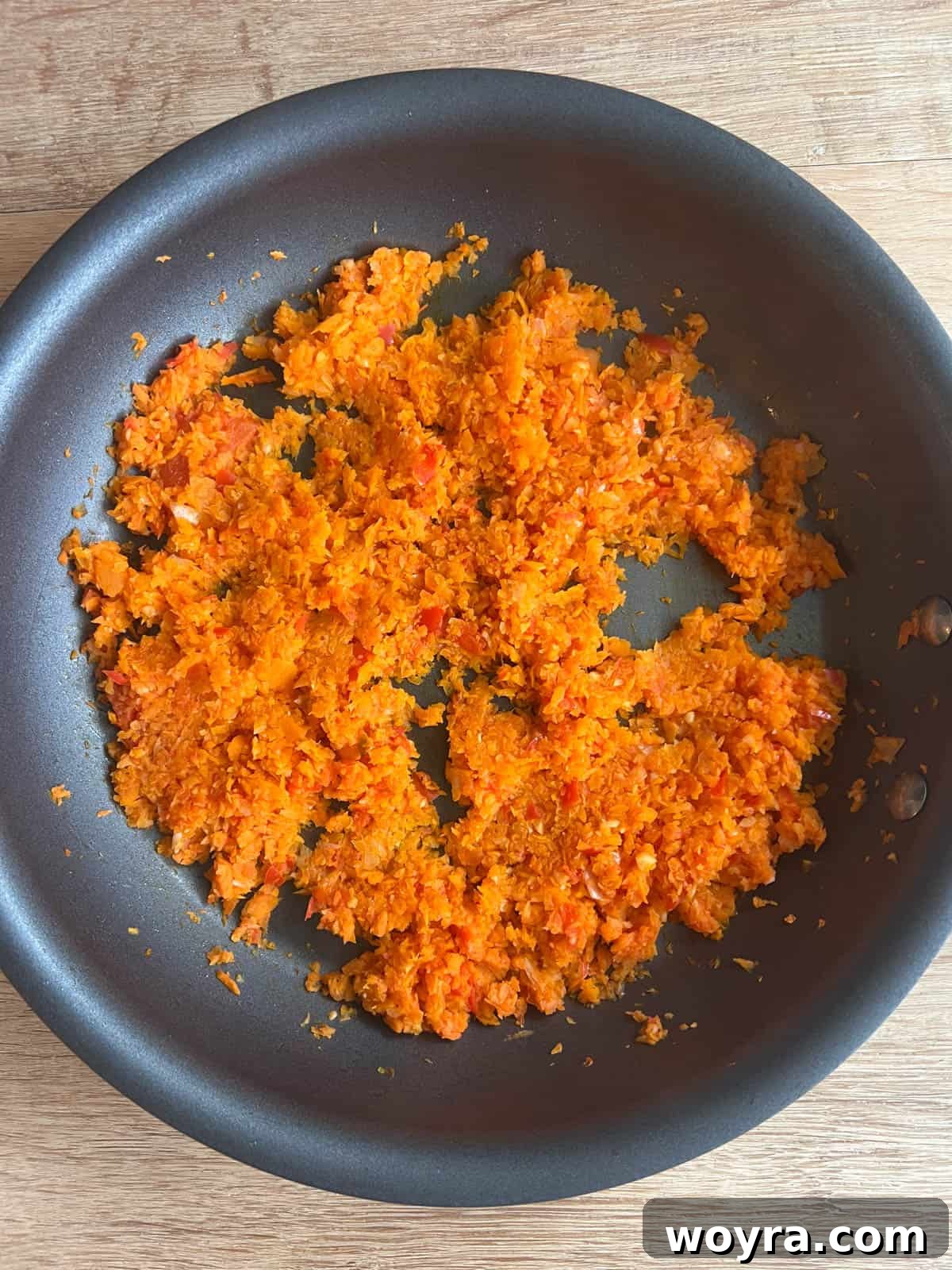 Clean Paleo Meatloaf 8 Sautéed garlic, onion, pepper, and carrot in a frying pan.