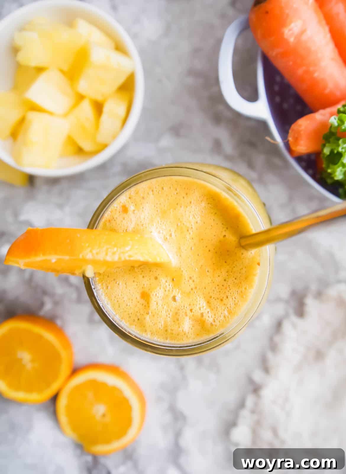 Green & Golden Tropical Quench 3 Freshly squeezed tropical kale and carrot juice in a mason jar, perfectly blended.