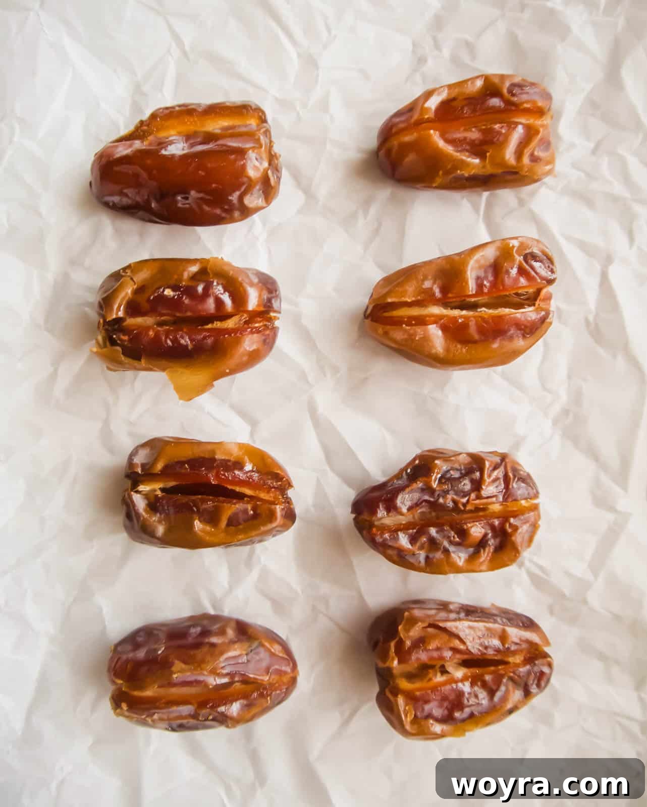 Crispy Bacon-Wrapped Raspberry Stuffed Dates 5 Dates on a cookie sheet.