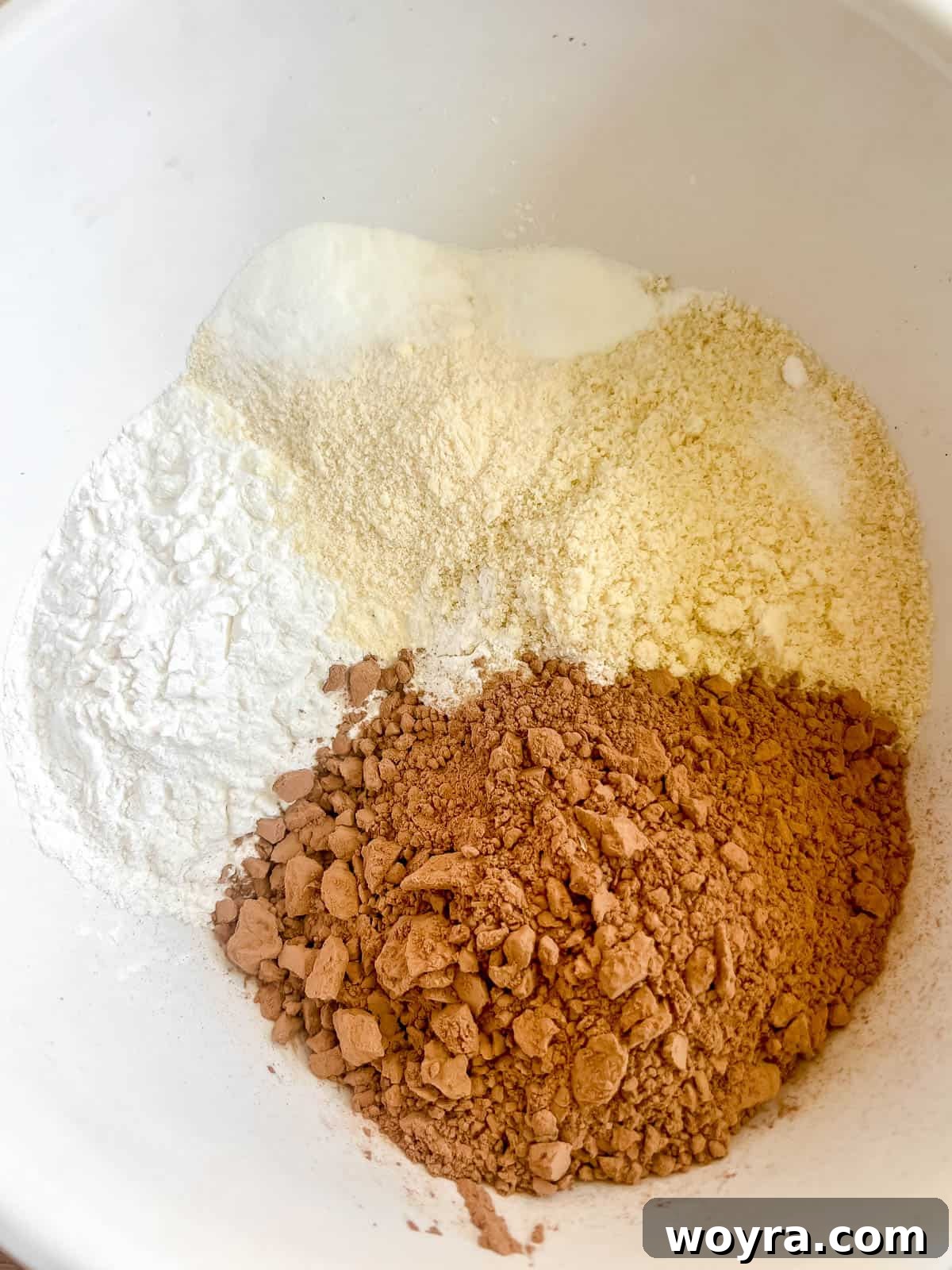 Decadent Paleo Chocolate Muffins 5 All the dry ingredients for chocolate muffins in a bowl, ready to be mixed.