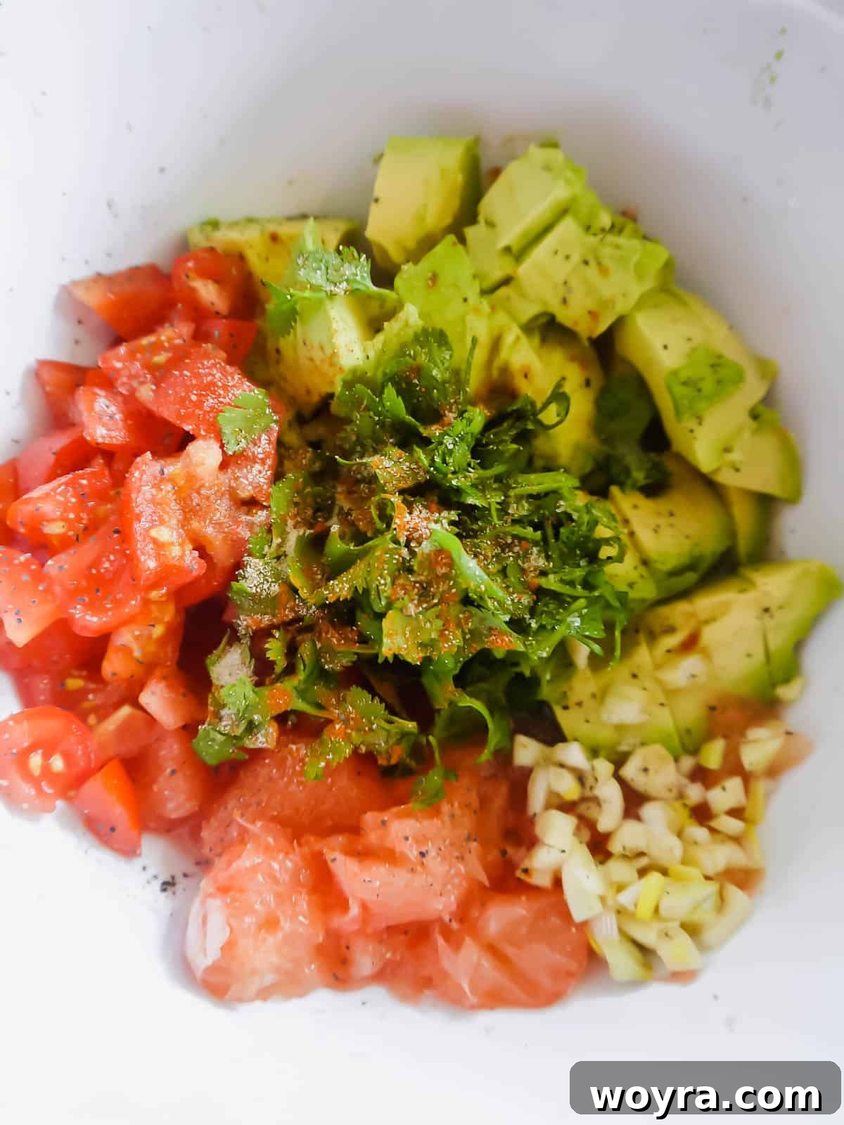 All the fresh ingredients meticulously laid out and ready for making grapefruit guacamole.