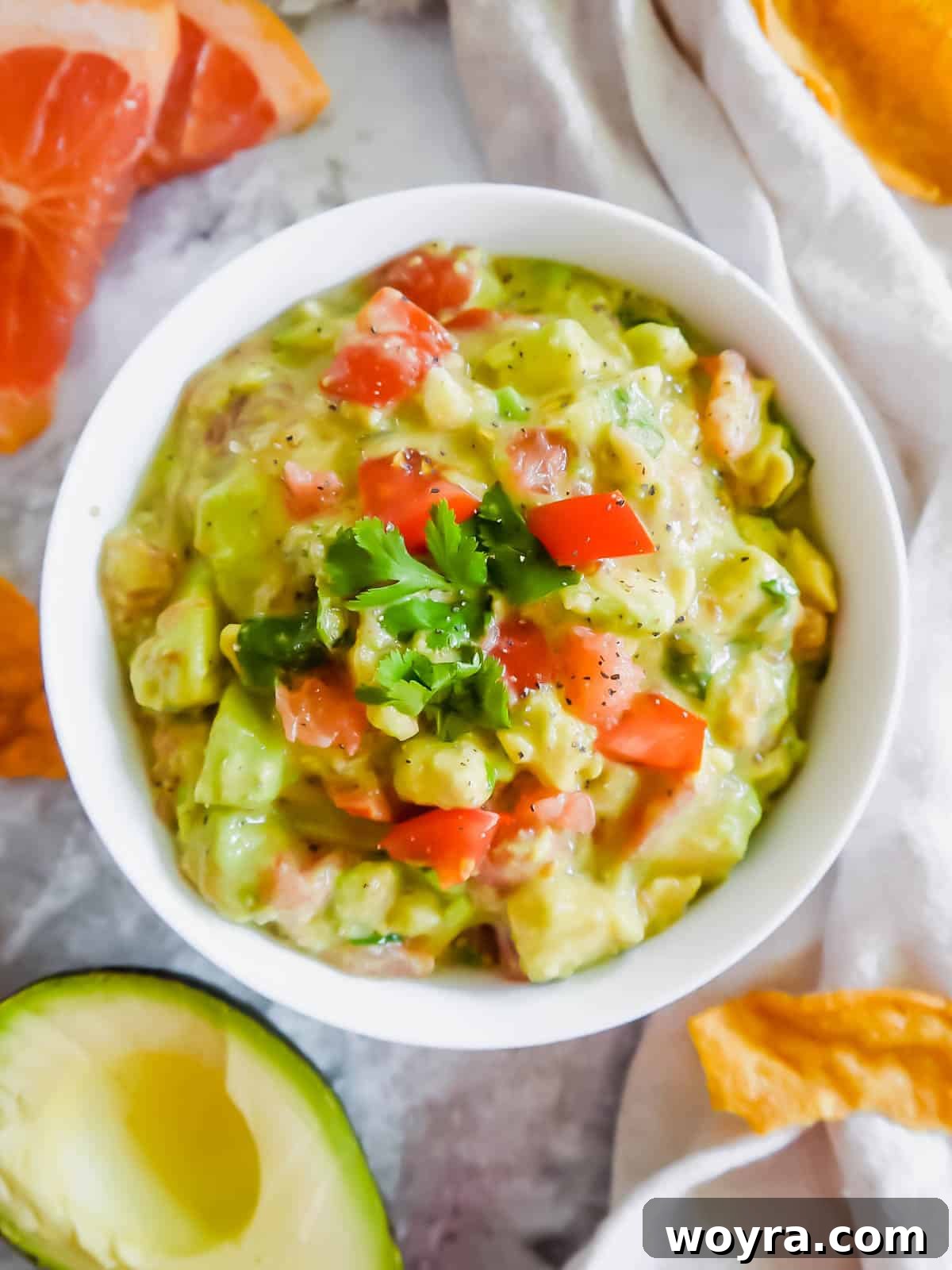 A large serving bowl filled with a generous portion of grapefruit guacamole, ready for a feast.