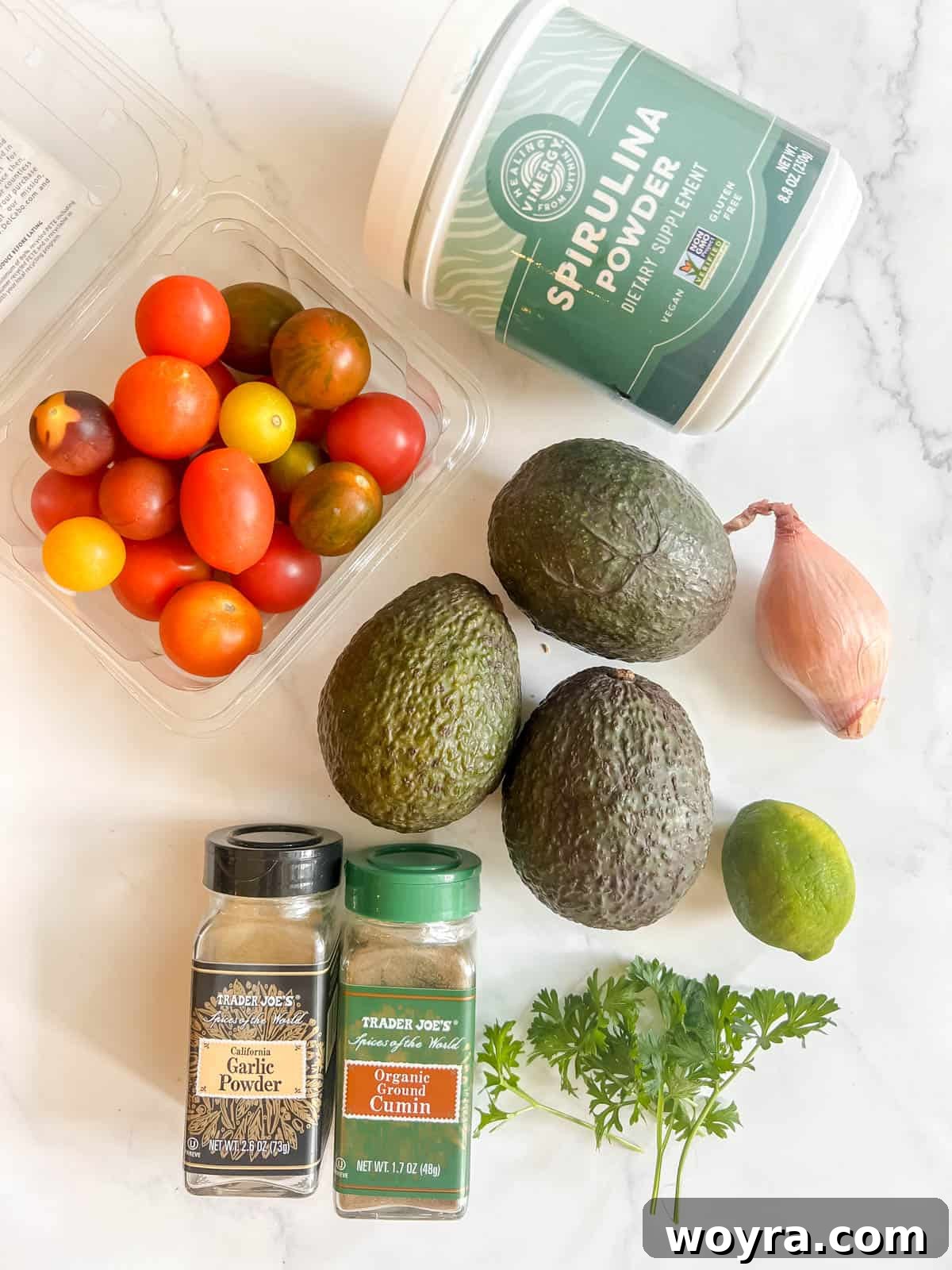 Green Power Guacamole 4 Fresh ingredients laid out for making Spirulina Guacamole: avocados, lime, tomatoes, onion, cilantro, and spices.