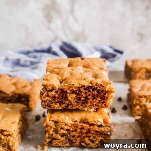 A beautifully baked gluten-free chocolate chip cookie bar with a golden-brown crust and melted chocolate chips.