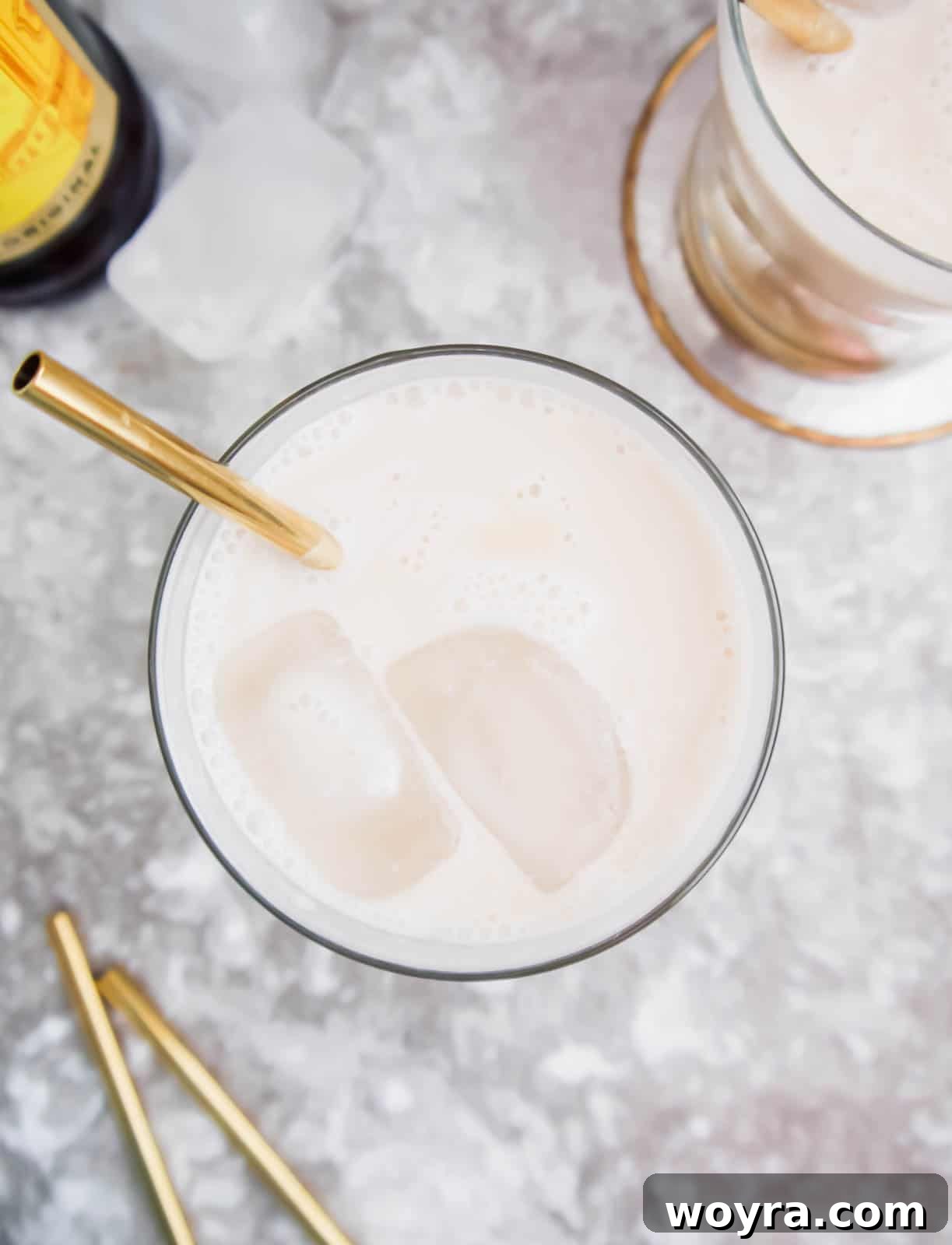 Velvet White Russian 3 Aerial view of white Russian, revealing ice cubes and the rich, swirling texture of the drink.