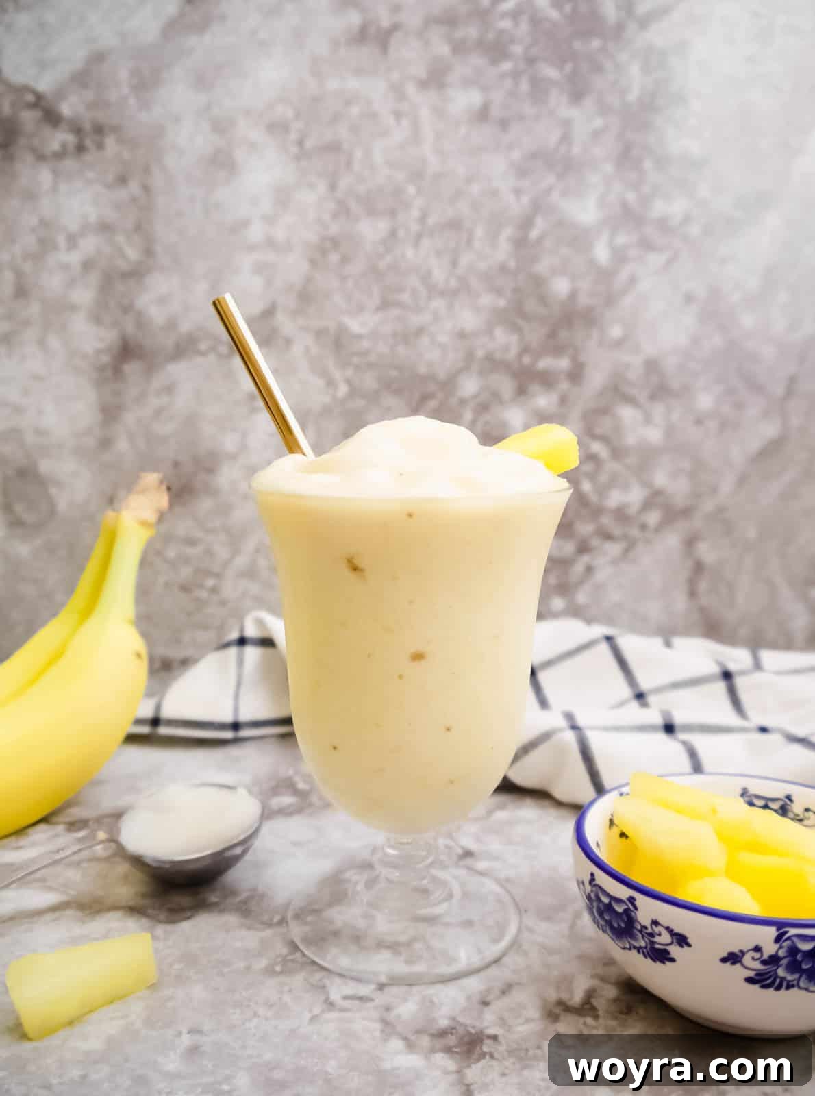 Close-up of the creamy Pineapple and Banana Coconut Oil Smoothie, showcasing its smooth texture and vibrant color.