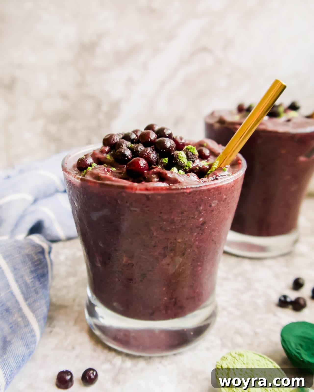 Wild Blueberry Super Green Smoothie 5 Side angle of blueberry orange smoothie in a glass.