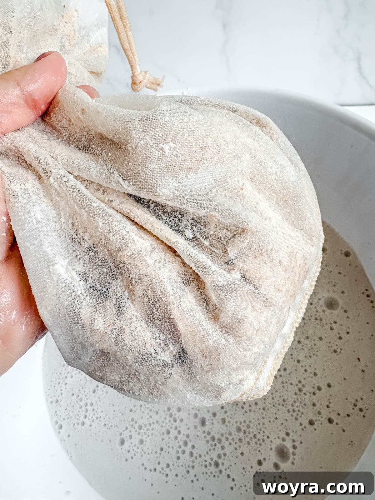 Homemade Strawberry Almond Milk: A Vegan Delight 12 The dense, dry almond pulp left inside a nut milk bag after all the liquid has been squeezed out, ready for disposal or other uses.