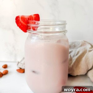 Homemade Strawberry Almond Milk: A Vegan Delight 16 Homemade strawberry almond milk in a mason jar, showing its vibrant pink color and smooth texture.
