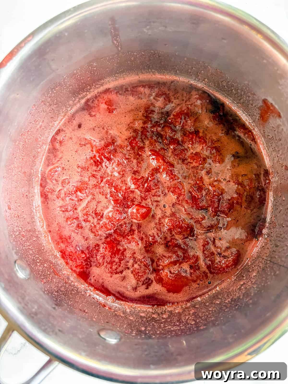 Homemade Strawberry Almond Milk: A Vegan Delight 5 Cooked strawberries gently simmering in a pot, having softened and begun to form a syrupy consistency.