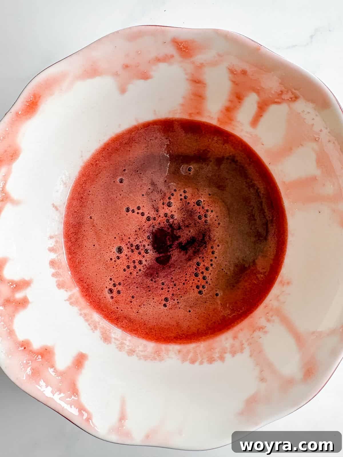 Homemade Strawberry Almond Milk: A Vegan Delight 7 A small bowl holding the rich, red homemade strawberry syrup, ready to be incorporated into the almond milk.