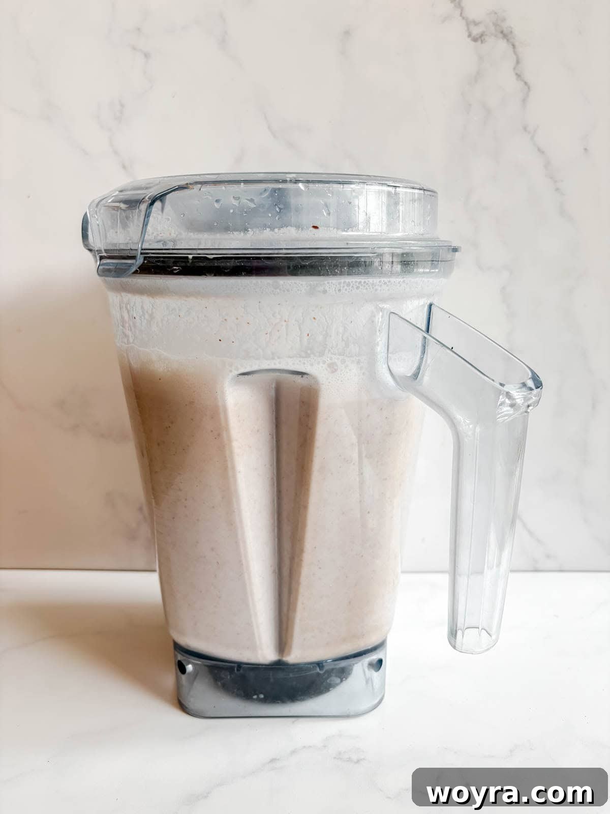 Homemade Strawberry Almond Milk: A Vegan Delight 9 The blended almond and strawberry mixture inside a high-speed blender, showing its frothy, milky consistency before straining.