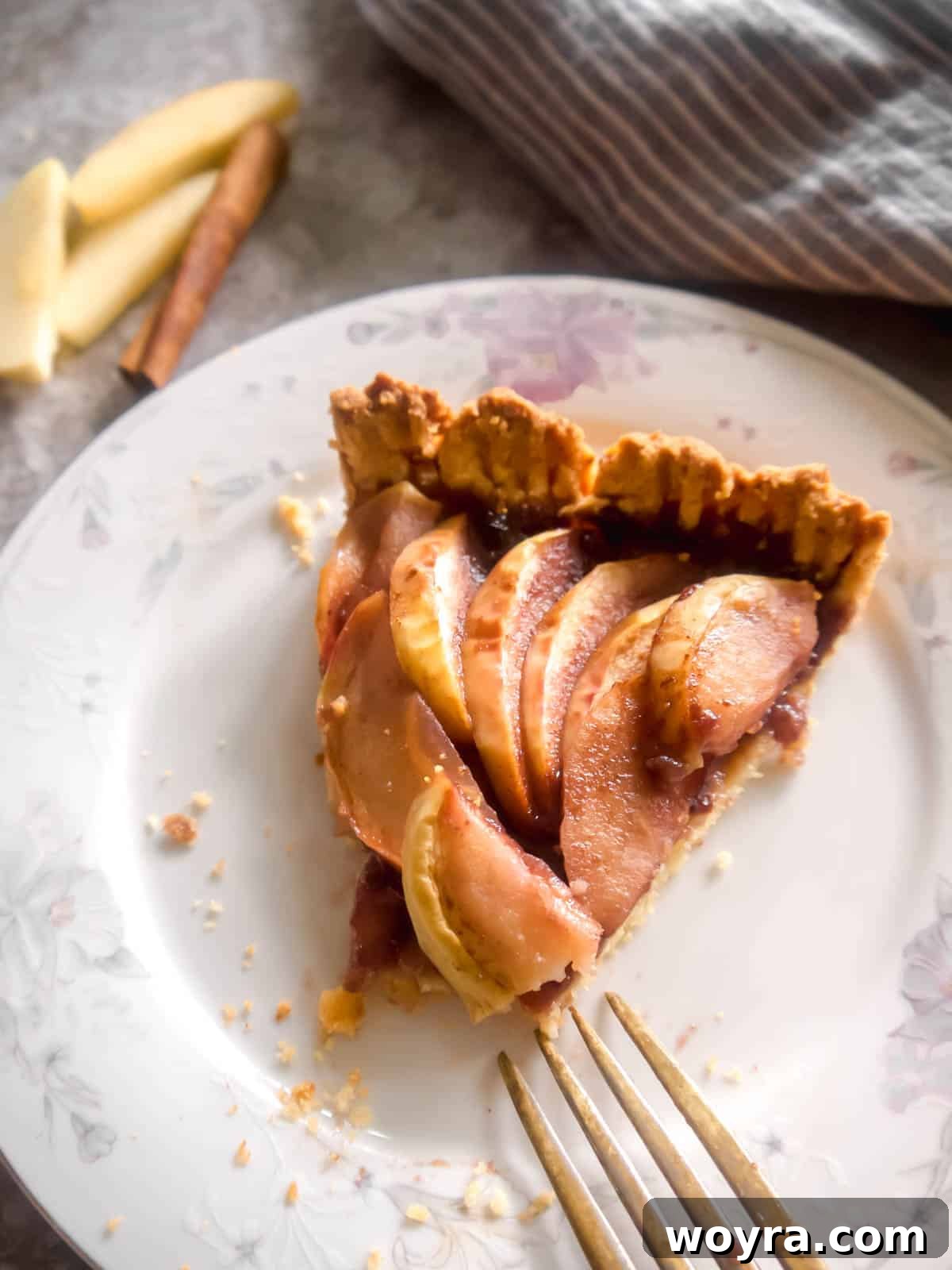 Ancestral Apple Indulgence 3 A perfectly baked slice of almond flour apple tart on a white plate, ready to be served.