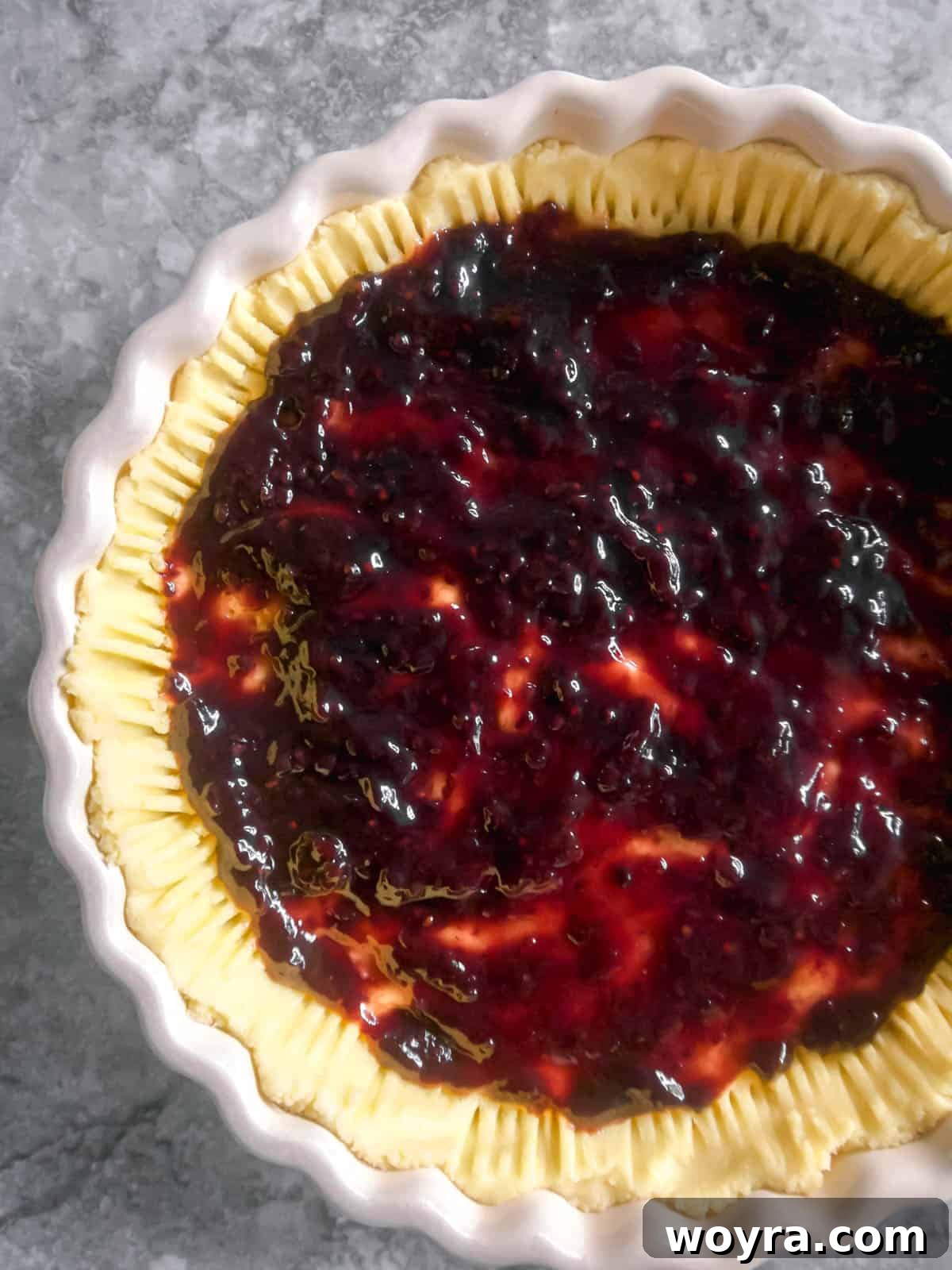 Ancestral Apple Indulgence 7 Sugar-free jam spread over the prepared tart crust.