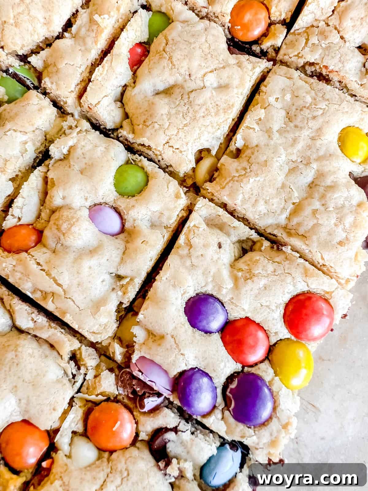 Deliciously Dairy-Free Gluten-Free Chocolate Chip Cookie Bars 11 Gooey chocolate chip cookie bars with chocolate candies inside, ready to be eaten.