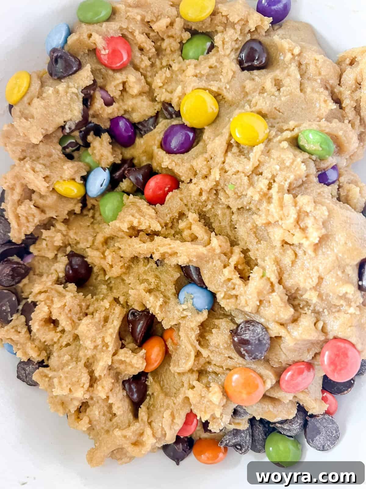 Deliciously Dairy-Free Gluten-Free Chocolate Chip Cookie Bars 7 Raw cookie bar dough with chocolate chips inside, ready to be spread.