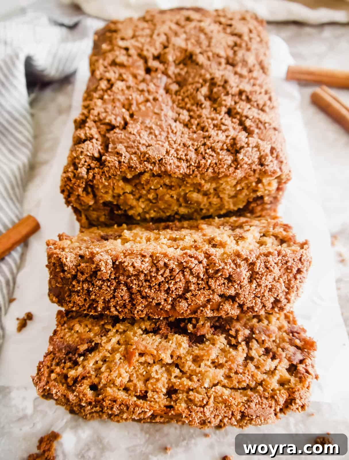 Coffee cake banana bread sliced warm out of the oven, revealing its moist interior and streusel layers.