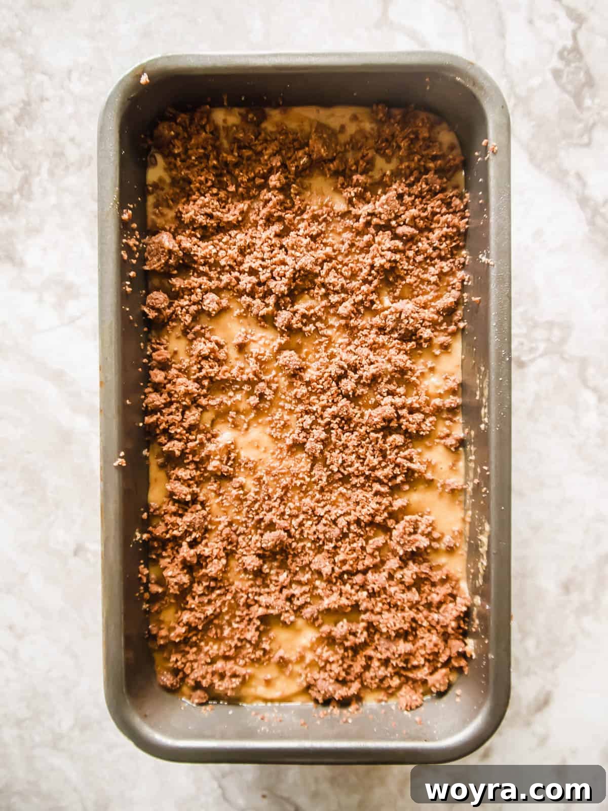 Gluten-free banana bread with final streusel topping before baking.