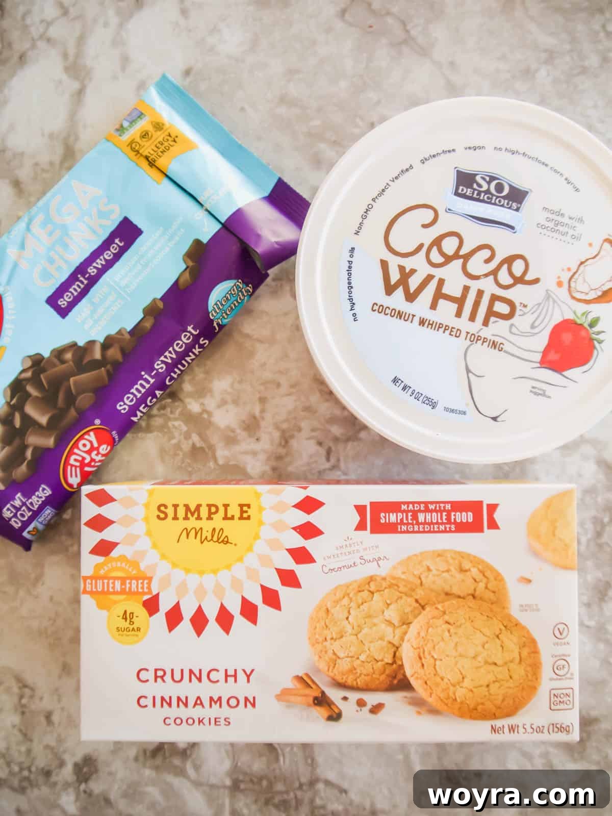 Velvety Chocolate Mousse Treats Dairy Free Gluten Free 3 A flat lay photograph showcasing the three primary ingredients needed to create dairy-free chocolate mousse balls: a tub of CocoWhip, a box of gluten-free cookies, and a bag of dairy-free chocolate chips.