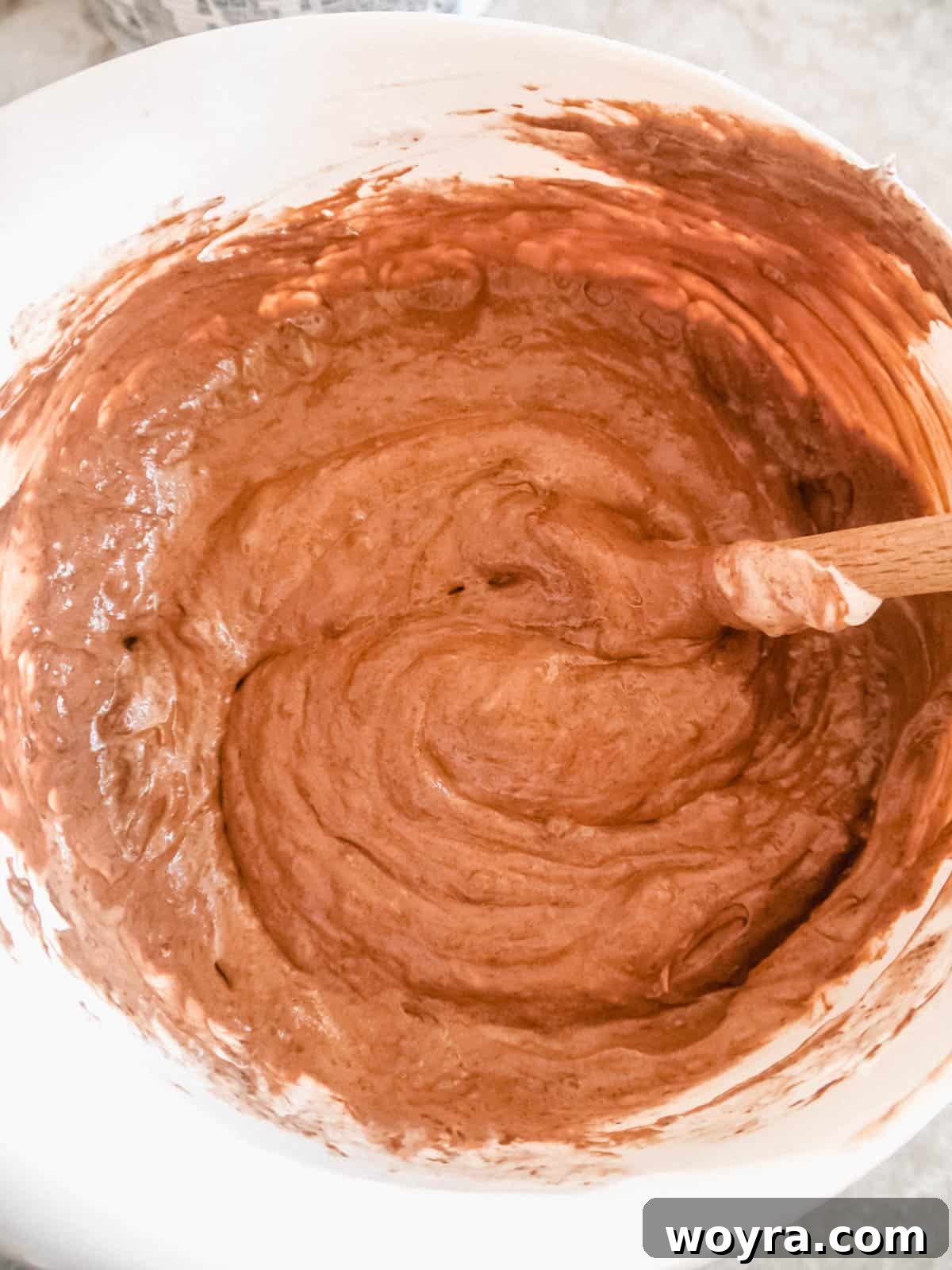 Velvety Chocolate Mousse Treats Dairy Free Gluten Free 7 Thawed CocoWhip and cooled melted dairy-free chocolate being gently folded together in a mixing bowl, creating the creamy base for the mousse balls.