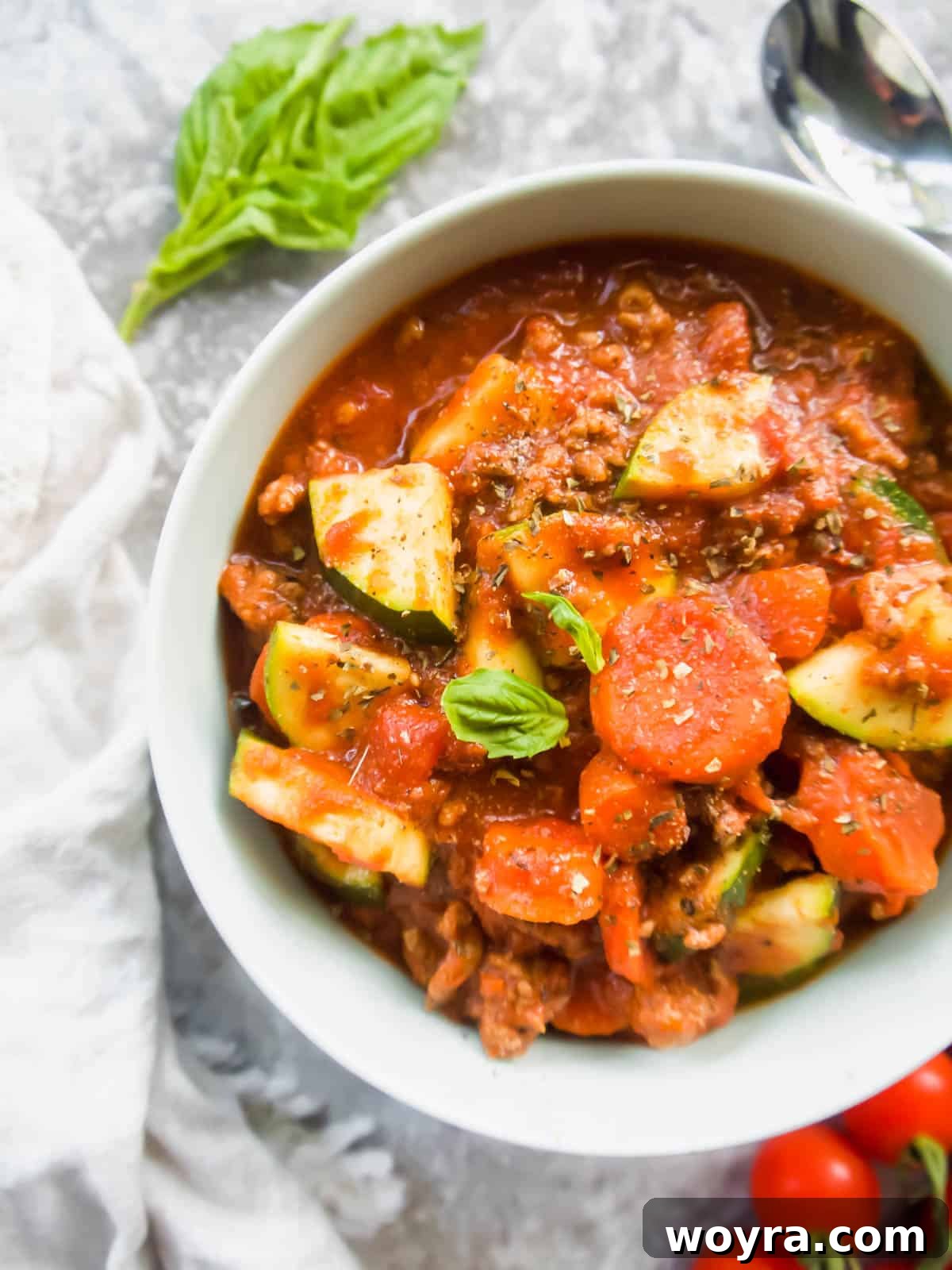 Whole30 veggie meat sauce in a bowl with fresh basil, ready to be served.
