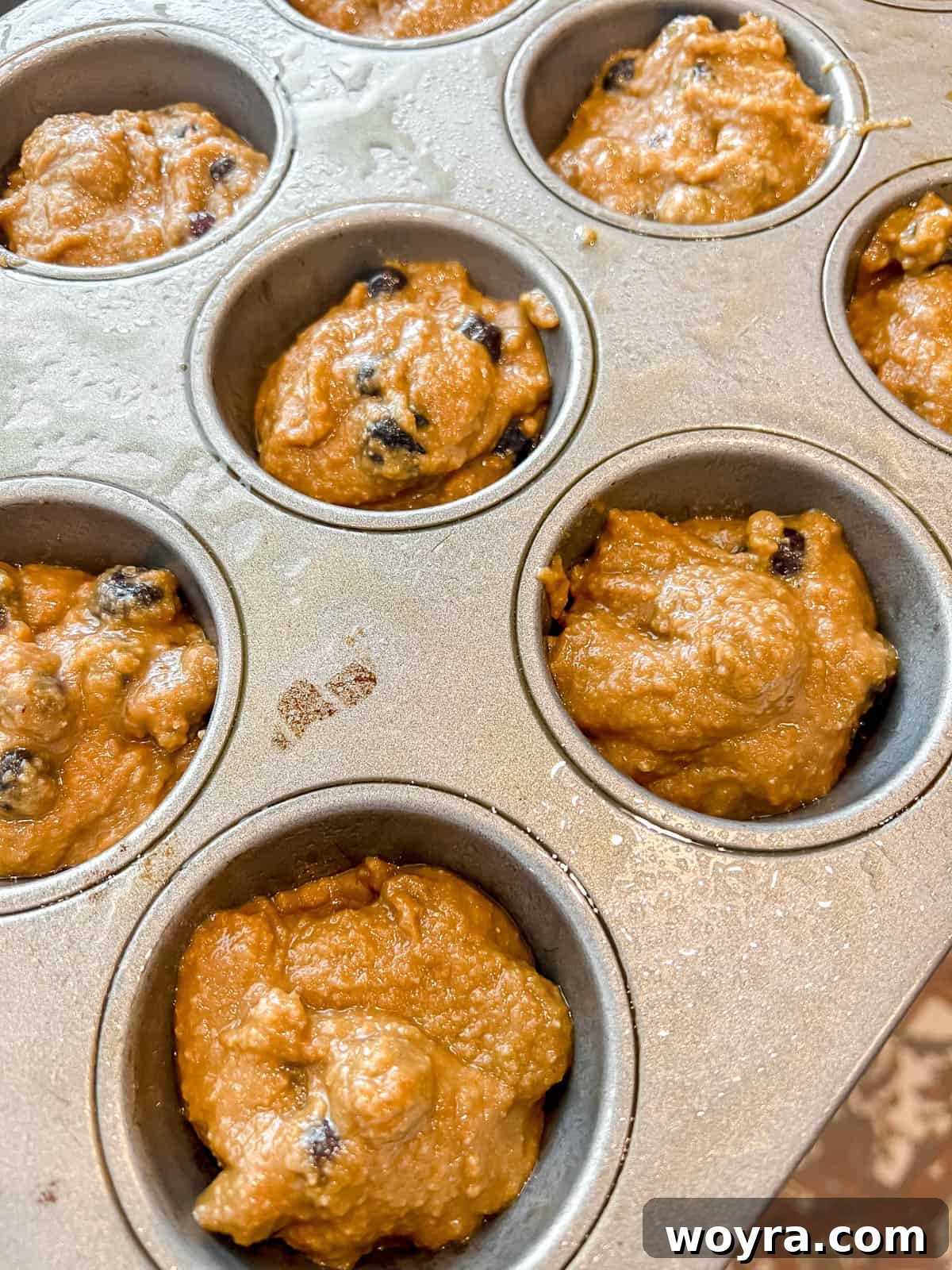 Grain-Free Blueberry Bliss Muffins 11 Paleo blueberry muffins batter placed in muffin tins before baking.