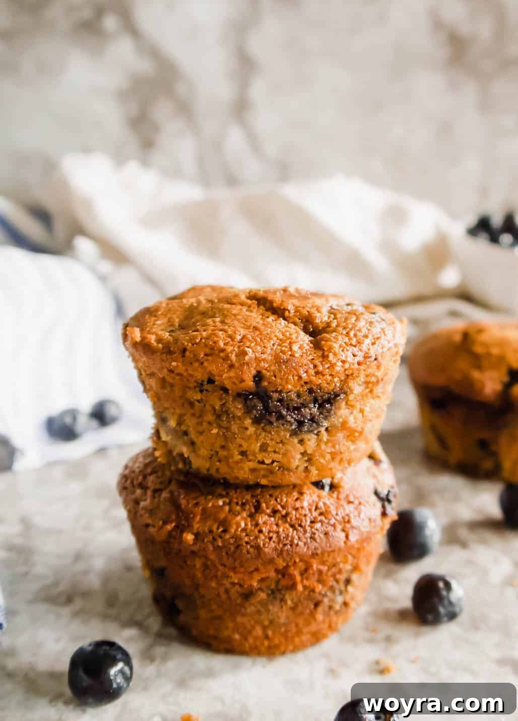 Grain-Free Blueberry Bliss Muffins 13 A stack of golden-brown Paleo blueberry muffins, showcasing their crisp tops.