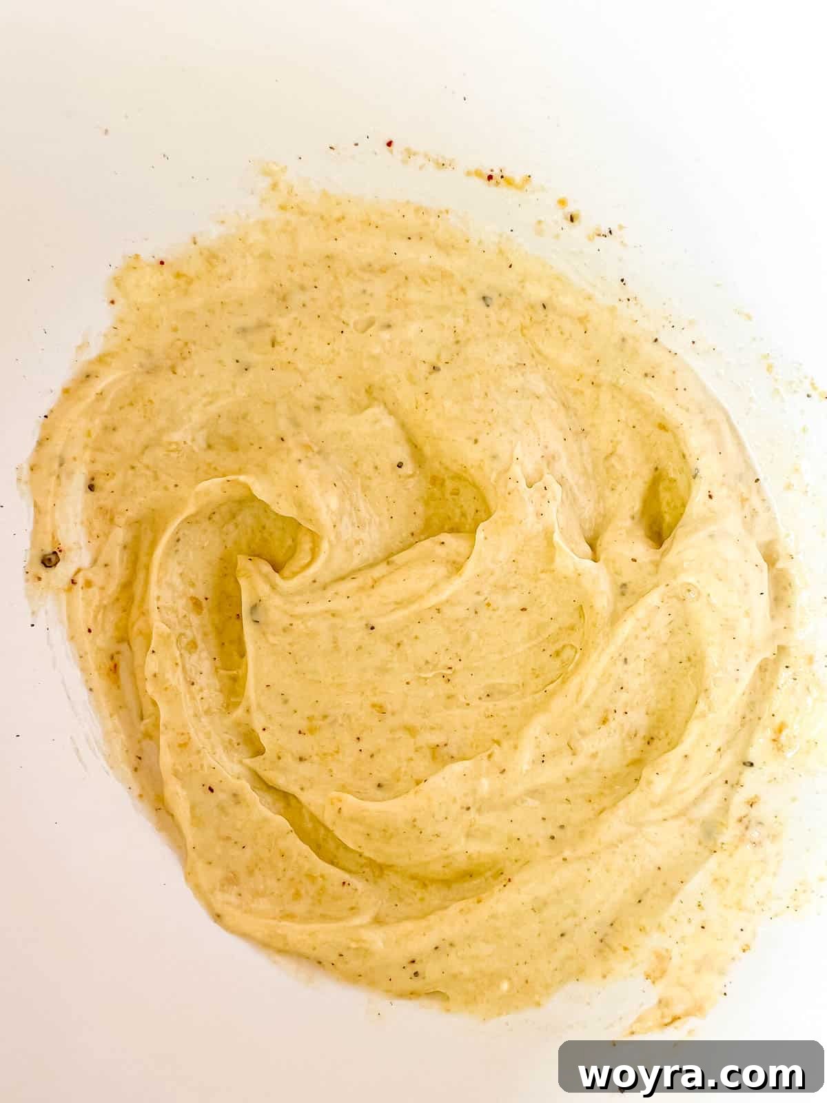 Plant-Based Mexican Street Corn 6 Dairy-free mayo and nutritional yeast sauce for the corn, mixed in a bowl.