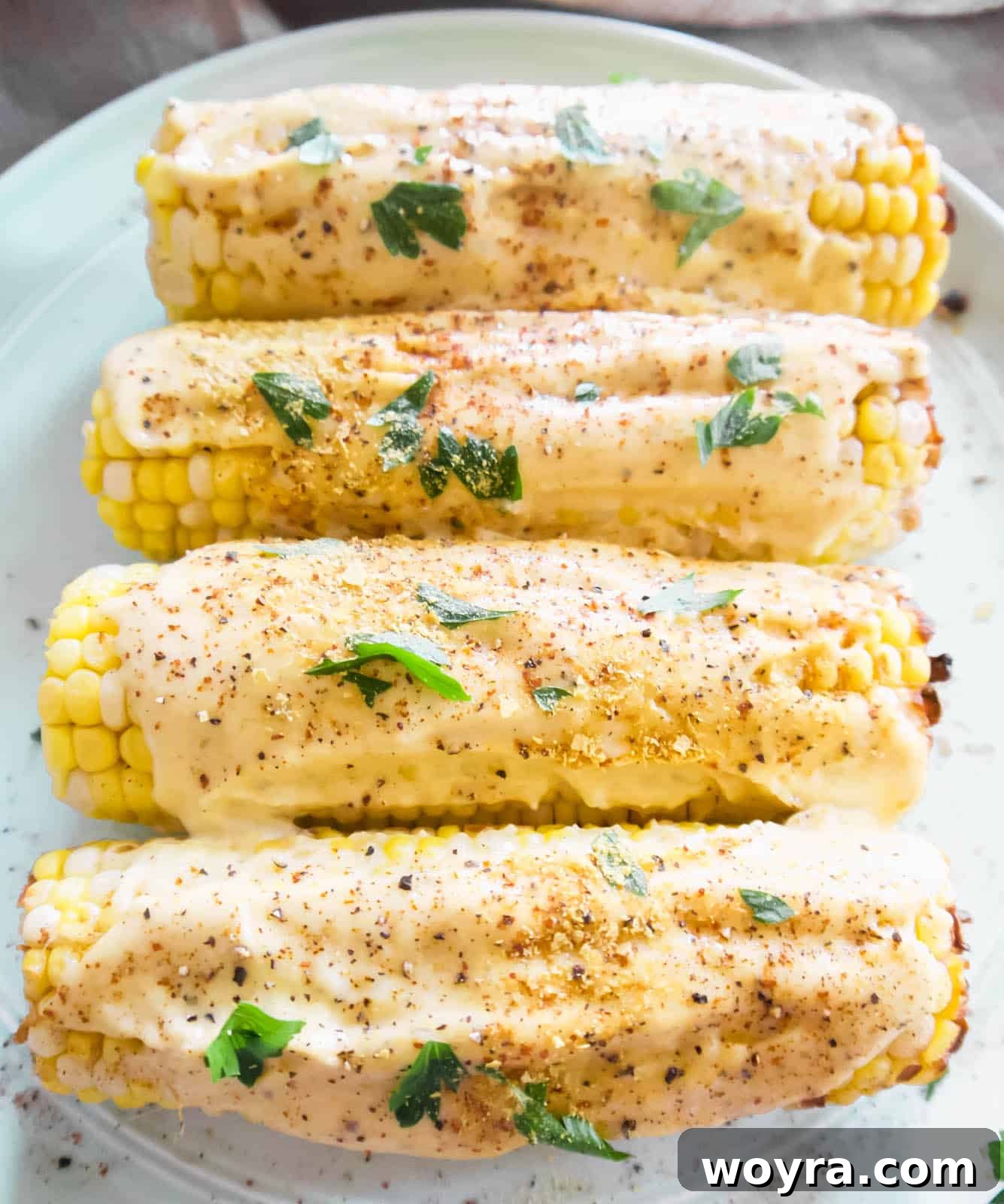 Plant-Based Mexican Street Corn 8 Vegan Mexican street corn elote on a plate with sauce on top, ready to serve.
