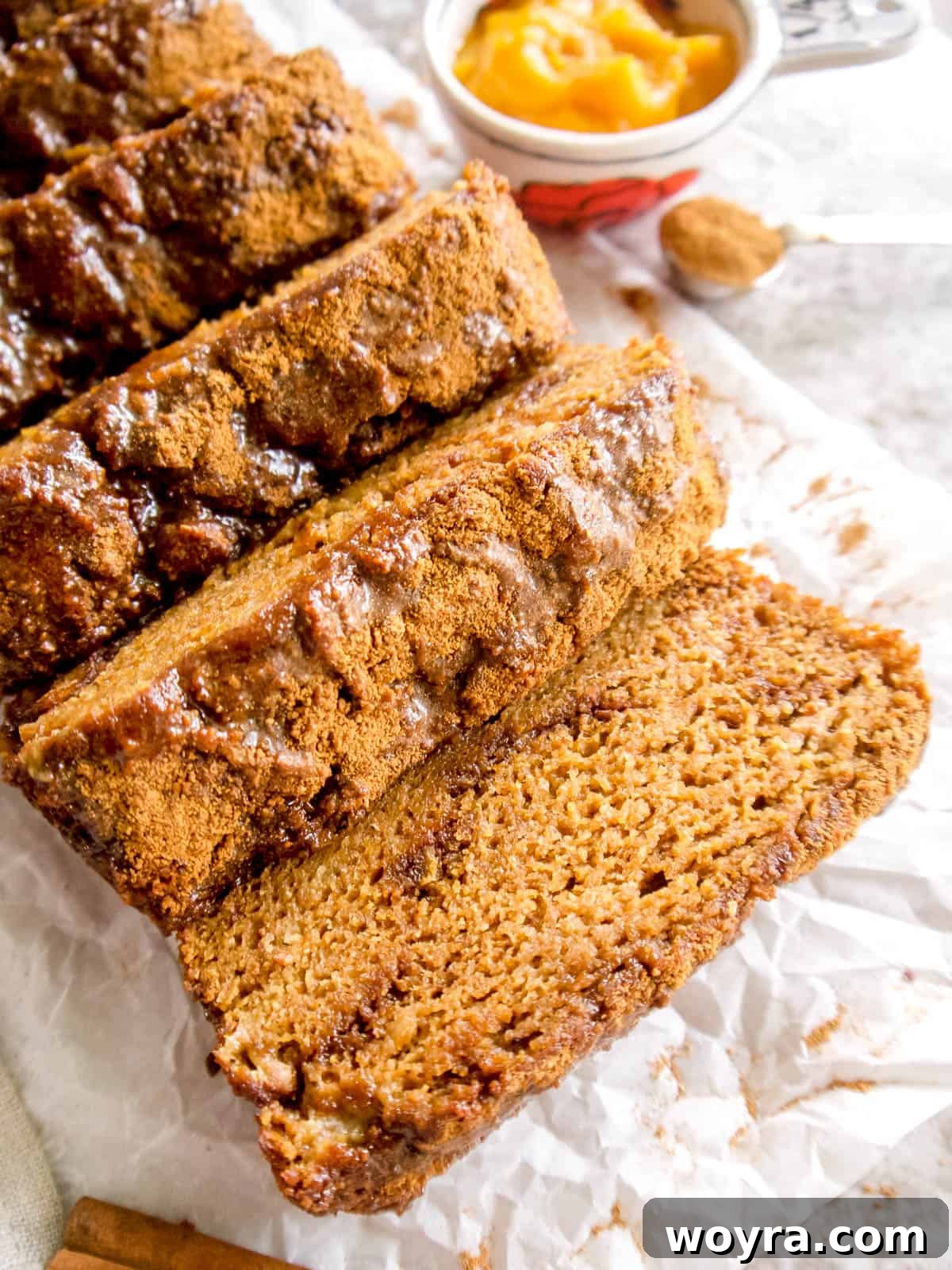 Wholesome Paleo Cinnamon Swirl Pumpkin Banana Bread 3 Close-up of a perfectly sliced loaf of gluten-free pumpkin banana bread, showing the cinnamon swirls and moist texture.